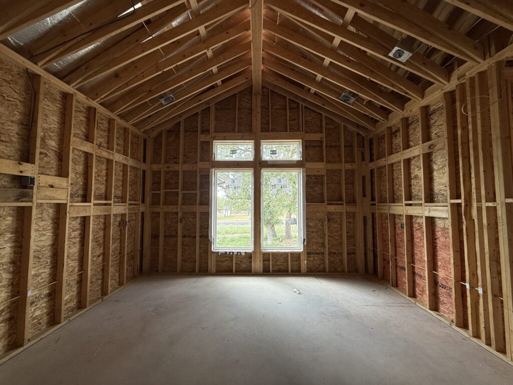 Custom home framing progress on residential lot in La Vernia, TX